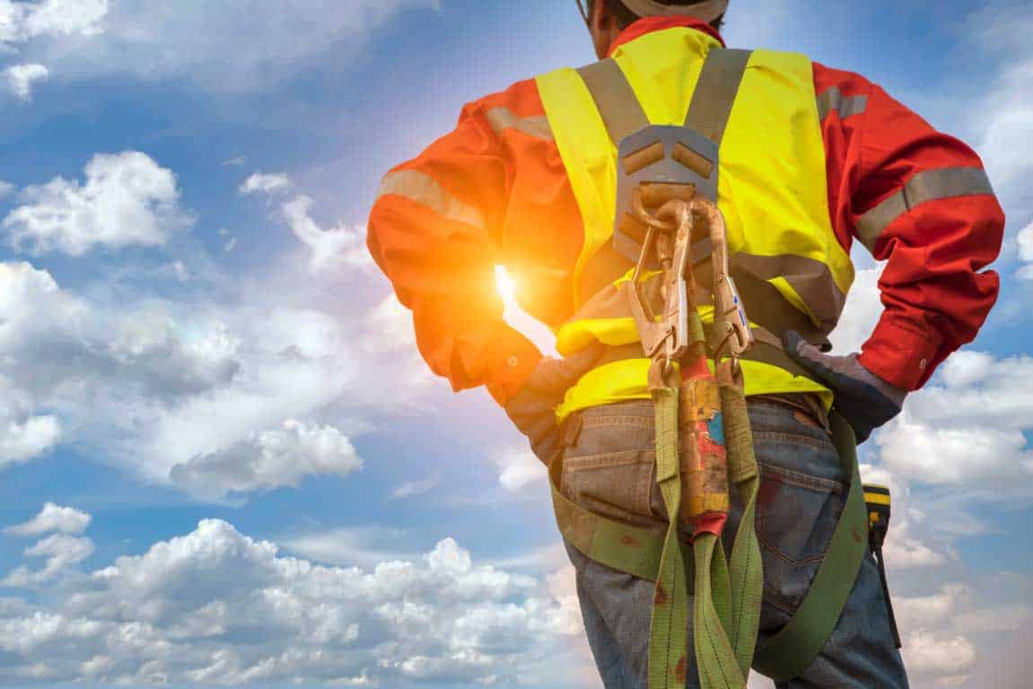 Engineer construction technician workers in savety protective cl Engineer construction technician workers in savety protective clothing with a relaxed posture after work. Engineer with sky background